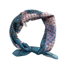 Floral print cotton linen neck scarf with blue and pink geometric patterns in a knotted loop