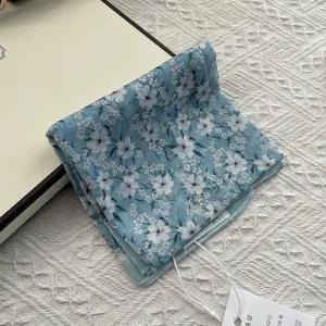 Blue floral cotton linen neck scarf with delicate white flowers and a rustic style