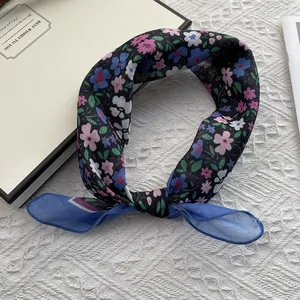 Detailed macro view of lightweight floral print scarf with soft chiffon panel edges