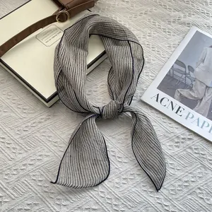 Linen plaid scarf with stripe texture and blue edges displayed on luxury backdrop