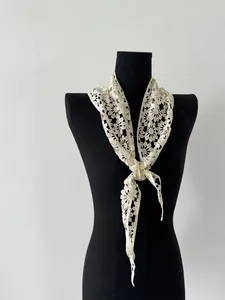 Detailed view of cream cotton lace shawl showing intricate floral crochet and hollow patterns