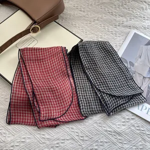 Detail of red and grey plaid pure linen scarves with premium fabric texture and edge stitching