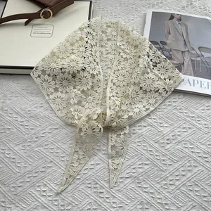 Detailed view of floral lace crochet daisy shawl with delicate hollow pattern and long ties