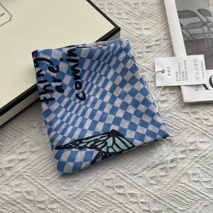 Blue checkerboard silk scarf with butterfly print and things are coming text detail