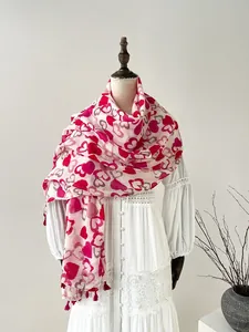 Detailed view of lightweight cotton linen scarf with red heart patterns and fringe tassels