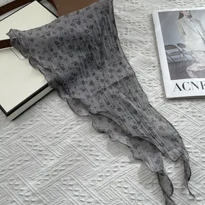 Floral gray cotton linen neck scarf with wavy edges on minimalist knit background