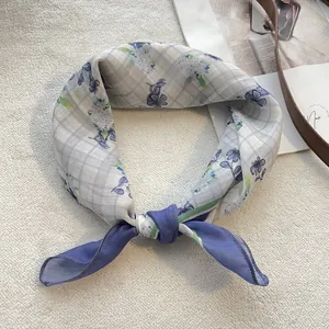 Detail of floral cotton square scarf with blue blossoms and fine purple hem stitching