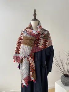 Detail of bohemian geometric scarf with colorful fringe on a display mannequin