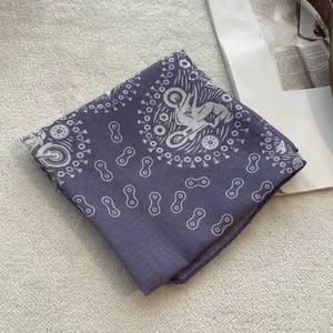 Detailed close-up of dark purple cotton floral scarf featuring motorcycle racing patterns