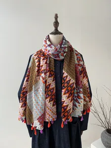 Detail of colorful geometric print shawl featuring tassels and bohemian patterns