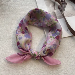 Detail of pink floral cotton linen square scarf showing soft texture and petal patterns