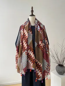Detail of bohemian geometric print scarf with colorful fringe tassels on a mannequin