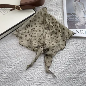 Detail of vintage floral cotton linen triangle scarf with scalloped edges and retro print