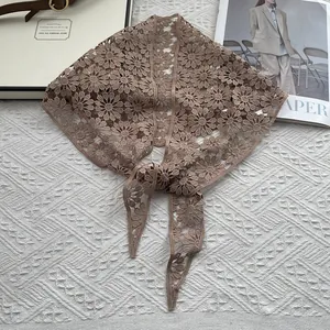 Detail of brown cotton lace shawl with daisy crochet pattern and elegant hollow-out design