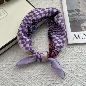Detailed close-up of purple checkered silk scarf with butterfly print and greetings text