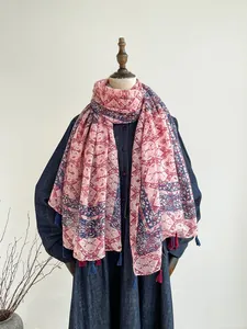Detail view of ethnic print scarf with dual-tone tassels and soft cotton texture