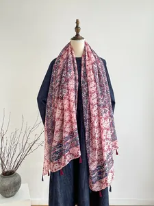 Detail of floral printed scarf with decorative tassels and breathable cotton linen fabric