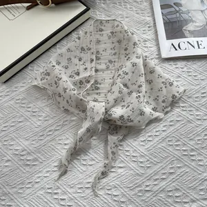 Detail of floral cotton linen triangular scarf with pleated texture and hemmed edges