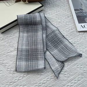 Elegant grey plaid cotton linen skinny scarf with fine hemmed edges on a white base