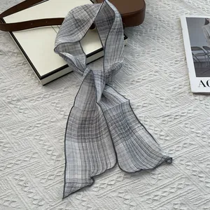 Elegant grey plaid skinny silk scarf for women styled with a minimalist leather handbag