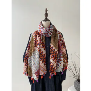 Bohemian geometric diamond print scarf with tassels on a minimalist studio backdrop