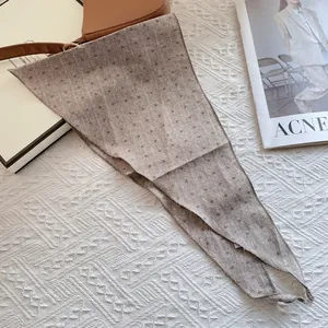 Brown floral cotton linen skinny scarf used as a hair tie or bag accessory for women