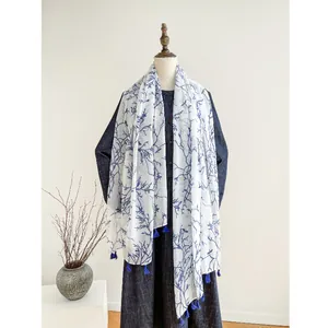 Blue and white porcelain style scarf with tassels on elegant mannequin display