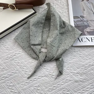 Gray-green floral cotton linen scarf with small flowers in a stylish knotted display
