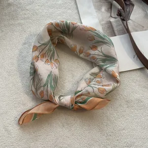 Detailed close-up of a cotton linen floral square scarf featuring orange tulip prints