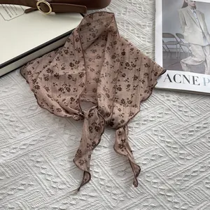 Detail of vintage floral cotton linen scarf with high-quality edge stitching and knot tie