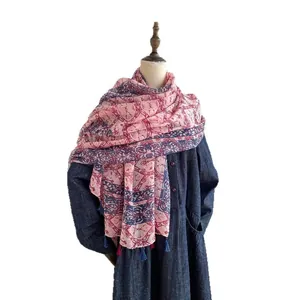 Ethnic style cotton scarf with pink floral patterns and tassels on a mannequin