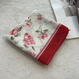 Detail view of Japanese floral cotton square scarf with red border on soft background
