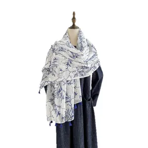Blue and white porcelain style lightweight scarf with tassels on female mannequin