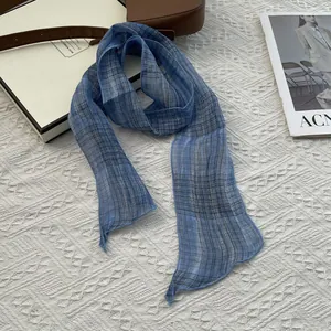 Detail of blue and gray plaid silk scarf with lightweight texture on woven background