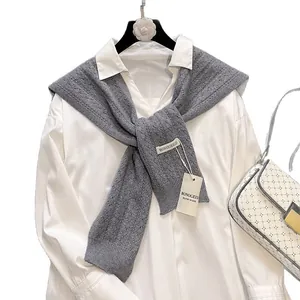 Chic grey hollow-out knitted shawl with ribbed edges styled over a white shirt