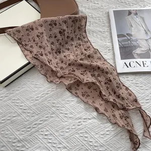 Detailed macro view of retro floral scarf featuring delicate wavy edges and light brown pattern