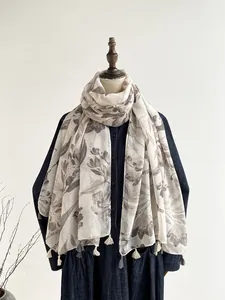 Detail of gray floral ink print on off-white cotton linen scarf with tassel edges