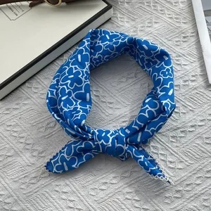 Close-up of blue floral cotton scarf with white lace trim and intricate crochet details