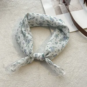 Detailed texture of lightweight cotton linen floral scarf with blue flower patterns