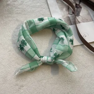 Detailed close-up of soft green floral cotton bandana with clover pattern for women