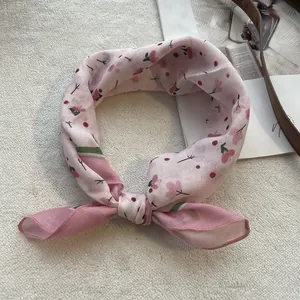 Detailed view of floral cotton linen headscarf with pink flower pattern and bow tie design
