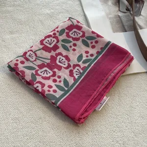 Macro shot of floral cotton linen headscarf showing neat stitching and pink flower patterns