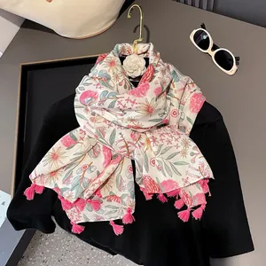 Floral cotton linen scarf with pink tassels shown on a black top with sunglasses