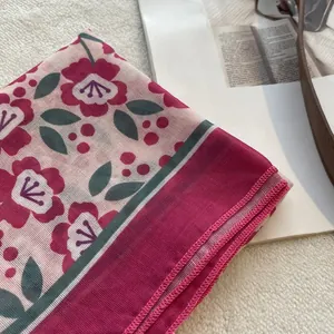 Detail of vintage floral cotton linen scarf with fine rolled edges and mesh texture