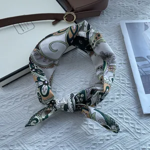 Detailed shot of retro paisley pattern scarf with dark green crochet lace edge trim