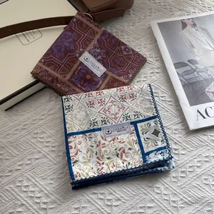 Detail of vintage paisley cotton scarves with ornate floral prints and blue crochet lace edge