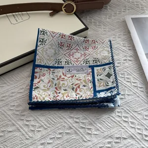 Vintage red paisley cotton scarf with blue crochet lace trim on white background