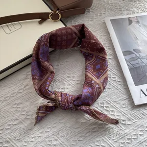 Detail of vintage floral pattern and golden edge stitching on cotton square scarf