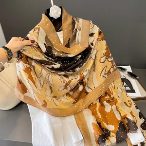 Detailed macro of a linen-blend scarf with abstract oil painting print and soft fringe