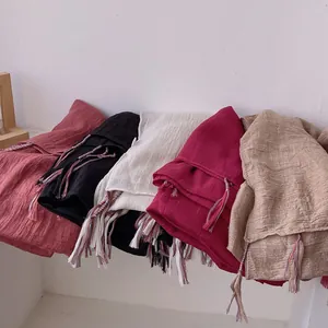 Linen and cotton scarves with fringes in various colors and wrinkled texture